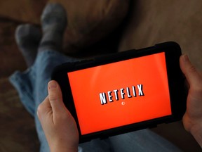 In this Friday, Jan. 17, 2014, file photo, a person displays Netflix on a tablet in North Andover, Mass. Netflix, Inc. reports financial results, Monday, July 17, 2017. (AP Photo/Elise Amendola, File)