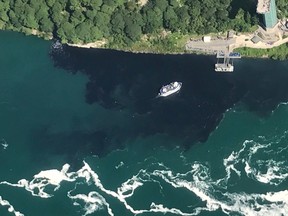 In this July 29, 2017 file photo provided by Rainbow Air INC., black-colored wastewater treatment discharge is released into water below Niagara Falls, in Niagara Falls, N.Y. Local lawmakers are asking for a criminal investigation into the discharge of wastewater that turned the water below Niagara Falls black.
 (Patrick J. Proctor/Rainbow Air INC. via AP)