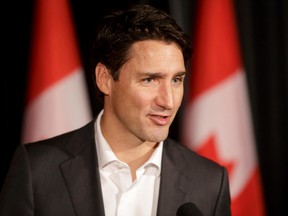 Prime Minister Justin Trudeau very briefly speaks to media during the federal Liberal cabinet retreat at the Fairmont Palliser in Calgary on  Jan. 24, 2017. (Lyle Aspinall/Postmedia Network)