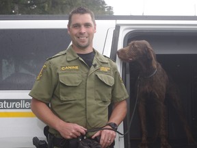 Ministry of Natural Resources conservation officer Nick Lees with crime-fighting dog Maya in Woodstock Friday. (HEATHER RIVERS/SENTINEL-REVIEW)