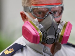 Sgt. Paul Manaigre, RCMP D Division, demonstrates some protective equipment at a media conference. Resources to protect officers from dangerous drugs were announced today, in Winnipeg. Friday, August 11, 2017. Chris Procaylo/Winnipeg Sun