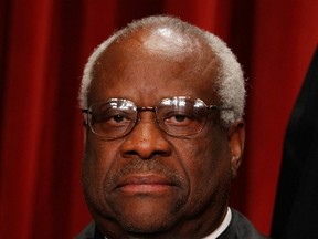 U.S. Supreme Court Associate Justice Clarence Thomas poses for photographs in the East Conference Room at the Supreme Court building October 8, 2010 in Washington, D.C. (Photo by Chip Somodevilla/Getty Images)
