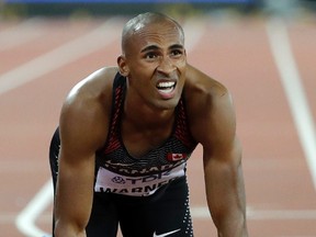 Canada's Damian Warner kneels on the track after racing in a Decathlon 400m heat during the World Athletics Championships in London on Aug. 11, 2017. (AP Photo/David J. Phillip)