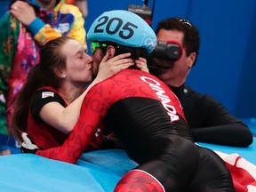 Charles Hamelin embraces Marianne St. Gelais after he won the men's 1500m short track speedskating final at the Iceberg Skating Palace during the Winter Olympics on Feb. 10, 2014, in Sochi, Russia. (AP Photo/Ivan Sekretarev)