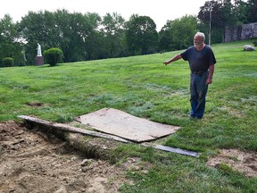 This Thursday Aug. 10, 2017 photo shows Mount Holiness Memorial Park caretaker Bill Plog as he stands by the burial plot of Cleveland Butler, in Butler, N.J. The New York Daily News reported the burial uncovered a moldering foot of a neighboring corpse that fell on top of Butler's coffin during the eulogy on Aug. 4, 2017. Plog said it's unfortunate that it happened, "but this is a graveyard." (James Keivom/The Daily News via AP)