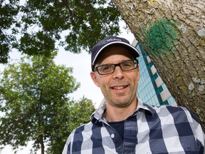 Jason Pollard, City of Ottawa Forester, surrounded by ash trees on Friday. Pollard says the Emerald Ash Borer infestation has passed its peak, but has taken out 50,000 trees since 2009.