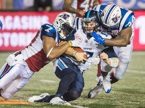 Toronto Argonauts quarterback Cody Fajardo is tackled by Montreal Alouettes during CFL action in Montreal on Aug. 11, 2017. (THE CANADIAN PRESS/Graham Hughes)
