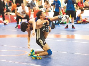 Team Manitoba’s Khaled Aldrar (bottom) competes in medal-round wrestling action at the Canada Summer Games yesterday in Winnipeg. Aldrar went on to win a silver medal. Matt Duboff/Canada Summer Games