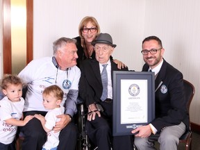 Thia handout file picture released by Guinness World Records on March 11, 2016 Marco Frigatti (R), Head of Records for Guinness World Records, presenting Israel Kristal (2nd-R) with his certificate of achievement for Oldest Living man, in the presence of the Kristal's daughter (top, son (L) and grandchildren. Israeli Holocaust survivor Yisrael Kristal, certified last year by Guinness World Records as the world's oldest man, died friday aged 113, Israeli media reported.(DVIR ROSEN/AFP/Getty Images)