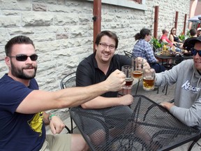 Doug McIntyre, Bill Ramore and Ben Bryan enjoy their frosty brews at the Elgin Street Craft Beer Festival in downtown Sudbury on Saturday. The festival was to continue until midnight. Ben Leeson/The Sudbury Star/Postmedia Network