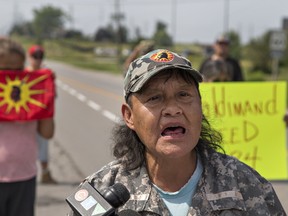 Doreen Silversmith, spokesperson for a group of native protestors reads a statement to media on Thursday August 10, 2017 near the site of a road blockade in Caledonia, Ontario. Protestors want the provincial government to return to the negotiating table over land claim issues, and want Six Nations Band Council to lift an injunction over farming the Burtch Lands near Branford. (Brian Thompson/Brantford Expositor/Postmedia Network)