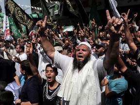 Palestinian protesters shout slogans during a gathering in the southern Gaza Strip city of Khan Yunis on July 22, 2017, as they protest against new Israeli security measures implemented at the holy site, which include metal detectors and cameras, following an attack that killed two Israeli policemen the previous week. Palestinian protesters clashed with Israeli forces outside Jerusalem's Old City as tensions mounted over new security measures at a highly sensitive holy site and prompted police to restrict access for Muslim prayers. / AFP PHOTO / SAID KHATIBSAID KHATIB/AFP/Getty Images