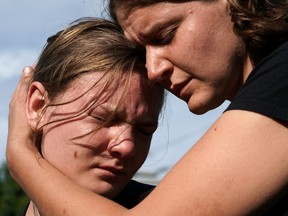 CHARLOTTESVILLE, VA - AUGUST 12:  Jessica Mink (R) embraces Nicole Jones (L) during a vigil for those who were injured and died when a car plowed into a crowd of anti-fascist counter-demonstrators marching near a downtown shopping area August 12, 2017 in Charlottesville, Virginia. The car allegedly plowed through a crowd, and at least one person has died from the incident, following the shutdown of the 'Unite the Right' rally by police after white nationalists, neo-Nazis and members of the 'alt-right' and counter-protesters clashed near Lee Park, where a statue of Confederate General Robert E. Lee is slated to be removed.  (Photo by Win McNamee/Getty Images)