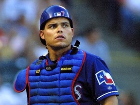 Ivan 'Pudge' Rodriguez leaves the field during early game action versus the Seattle Mariners at the Ballpark in Arlington in Arlington, Texas, July 2001. (Paul Buck/AFP/Getty Images)