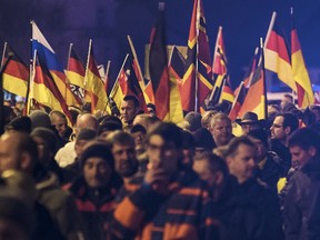 People hold flags in Erfurt, Germany, during a demonstration initiated by the Alternative for Germany party against the immigration situation on March 16, 2016. (Jens Meyer/AP Photo/Files)