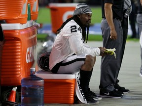 Raiders running back Marshawn Lynch sits during the U.S. anthem prior to the team's preseason game against the Cardinals in Glendale, Ariz., on Saturday, Aug. 12, 2017. (Rick Scuteri/AP Photo)