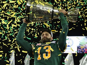 Edmonton Eskimos QB Mike Reilly hoists the Grey Cup after defeating the Ottawa RedBlacks in the 2015 CFL championship at Investors Group Field in Winnipeg on Nov. 29, 2015. The time has come for the CFL to make a radical change to its antiquated playoff format. The divide between East and West is just too great. Kevin King/Winnipeg Sun/Postmedia Network