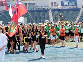 Team Manitoba arrives during the Parade of Athletes at the closing ceremony for the 2017 Canada Summer at Investors Group Field in Winnipeg, Man., on Sunday, August 13, 2017. Pictured: Team Manitoba flag bearer Maddy Mitchell. (Brook Jones/Postmedia Network)