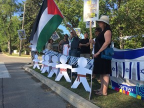 A group of Winnipeggers protest for Palestine outside the Israel - Shalom Square Folklorama pavilion on Sunday, Aug. 13, 2017, standing across the street from the pavilion entrance at the Asper Jewish Community Campus in Winnipeg. They plan to hold a similar vigil on Wednesday, Aug. 16, 2017. JASON FRIESEN/Winnipeg Sun/Postmedia Network