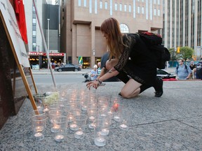 People gather at the Human Rights Monument in Ottawa on Sunday, August 13, 2017, in support of those injured and killed yesterday in Charlottesville, Virginia.