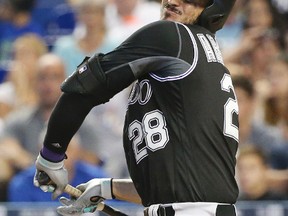 Colorado Rockies' Nolan Arenado reacts after being hit by a pitch during the fifth inning of a baseball game against the Miami Marlins, Sunday, Aug. 13, 2017, in Miami. Major league RBI leader Arenado left the game after being hit by a fastball thrown by Marlins' Vance Worley. (AP Photo/Wilfredo Lee)