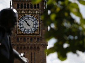The statue of former British Prime Minister David Lloyd George is silhouetted against the Queen Elizabeth Tower which holds the bell known as 'Big Ben' in London, Monday, Aug. 14, 2017. Big Ben will fall silent next week in London as a major restoration project gets underway. The bongs of the iconic bell will be stopped on Aug. 21 to protect workers during a four-year, 29-million-pound ($38 million) conservation project that includes repair of the Queen Elizabeth Tower, which houses Big Ben and its clock. (AP Photo/Alastair Grant)