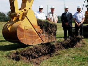 County CAO Peter Crockett, warden David Mayberry, deputy-warden Trevor Birtch and public works director David Simpson (from left to right) break ground with an excavator on the county's new waste management administration facility in Salford on Thursday. (BRUCE CHESSELL/Sentinel-Review)
