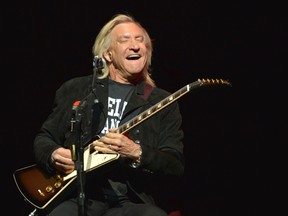 In this Jan. 15, 2014, file photo, Joe Walsh of The Eagles performs on the "History of the Eagles" tour at the Forum in Inglewood, California. Walsh and the rest of the Eagles announced Aug. 14, 2017, that they would be heading out on tour with the son of founding member Glenn Frey stepping in for his late father. (Photo by John Shearer/Invision/AP, File)