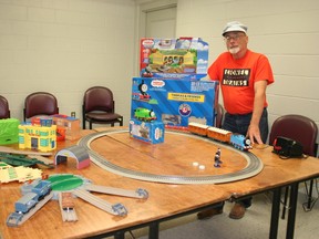 Model train collector David Onn poses with the Thomas the Train layouts — borrowed from his grandkids — that will be set up at Sloman Park for children of the community to enjoy on August 19 during this year’s Thomas Day Children’s Festival.