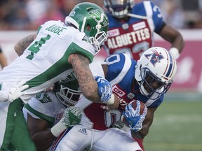 Montreal Alouettes running back Stefan Logan is tackled by Saskatchewan Roughriders linebacker Cameron Judge during first quarter CFL football action in Montreal on Thursday, June 22, 2017.  If the season ended today, the Saskatchewan Roughriders would miss the playoffs entirely, while the Montreal Alouettes would host the East Final — both with the same sub. 500 record. THE CANADIAN PRESS/Paul Chiasson