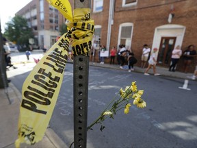 On Sunday, Aug. 13, 2017, police tape and flowers mark the site where a car plowed into a crowd of people protesting a white nationalist rally on Saturday in Charlottesville, Va. (AP Photo/Steve Helber)