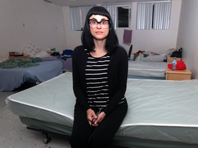 Cindy Titus, fund development co-ordinator at Main Street Project, sits on a vacant bed at its facility on Martha Street in Winnipeg on Mon., Aug. 14, 2017. They are receiving a number of bunk beds which are being donated after use for the Canada Summer Games. Kevin King/Winnipeg Sun/Postmedia Network