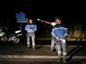 Police officers block a road approaching the town of Sept-Sorts, about 65 kilometres east of Paris, France after an incident when a driver slammed his car into the sidewalk cafe of a pizza restaurant, Monday, Aug. 14, 2017. (AP Photo/Kamil Zihnioglu)