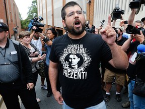 Matthew Heimbach, centre, voices his displeasure at the media after a court hearing for James Alex Fields Jr., in front of court in Charlottesville, Va., Monday, Aug. 14, 2017.  (AP Photo/Steve Helber)