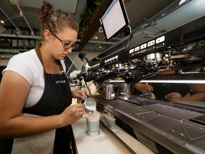 Kyra Hetherington makes a cappuccino at the newly opened Monument Coffee, 10803 Jasper Avenue, in Edmonton Monday Aug. 14, 2017. Photo by David Bloom