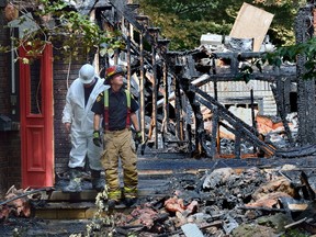 A London firefighter hoses down the remains of a home at 4 Aspen Place in Lambeth Monday, four days after it was destroyed in a late-night fire. The owners had moved in less than a month before the blaze. (MORRIS LAMONT, The London Free Press)