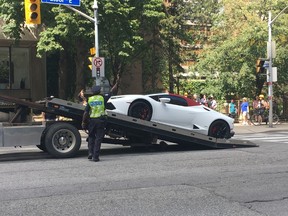 Police put a Lamborghini on a flatbed truck on Bloor St., near Jarvis St. (JON MCCARTHY PHOTO)