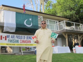 Syed Atta-ur-Rehman, president of the Pakistan Canada Association of Kingston, sets up decorations in preparation for a celebration of Pakistan’s Independence Day at the Bayside Inn on Bath Road.  (Ashley Rhamey/For The Whig-Standard)