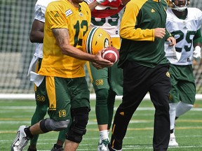 Edmonton Eskimos quarterback Mike Reilly jogging with head coach Jason Maas during practice at Clarke Stadium in Edmonton, August 14, 2017.