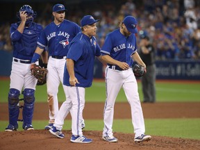 TORONTO, ON - AUGUST 12: Chris Rowley #45 of the Toronto Blue Jays exits the game as he is relieved by manager John Gibbons #5 in the sixth inning during MLB game action against the Pittsburgh Pirates at Rogers Centre on August 12, 2017 in Toronto, Canada. (Tom Szczerbowski/Getty Images)