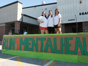 The creators of the event known as Run4MentalHealth Nicole Morey, Terri Lyn Devereaux and Kristen Devereaux pose for a photo last Sunday in front of the Seaforth Arena. (Shaun Gregory/Huron Expositor)