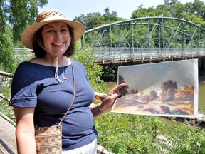 Susan Butlin, a historical interpreter with Eldon House, stands near Blackfriars Bridge while holding an image depicting London’s past. Butlin is leading walking tours Eldon House has made available to the public on upcoming Wednesdays this August. (CHRIS MONTANINI, Londoner)