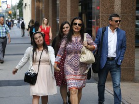 The Munoz family arrives at Toronto Police HQ for the first day of a tribunal against two officers and their comments towards daughter Francie, also in photo sister Yasmin, and parents Pamela and Carlos on Tuesday August 15, 2017. (Michael Peake/Toronto Sun)
