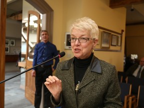 Marilyn Lawrie speaks to city council soon after her hiring in March as executive director of the Belleville Downtown Improvement Area. The group's chairman, Dwane Barratt (background), said Tuesday Lawrie has resigned and the board will make a related announcement Wednesday.