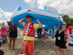 In this file photo, Harrison Plain, of Sarnia, waits to put his inflatable into the water for the Port Huron Float Down at Lighthouse Beach in Port Huron, Mich., last August. This year's float down is set for Sunday afternoon on the St. Clair River. Last year, a large number of U.S. citizens were blown ashore in Sarnia during the event.
Mark R. Rummel/The Times Herald via AP