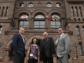 Concussion Legacy Foundation (CLF) co-founder and CEO Chris Nowinski, PhD (left) and Tim Fleiszer, executive director of CLF Canada (right) pose out front of Queen's Park with Gordon and Kathleen Stringer (middle) to announce a new national concussion awareness campaign on Aug. 15, 2017. (Jack Boland/Toronto Sun/Postmedia Network)