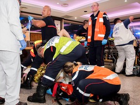 This photo provided Tuesday Aug. 15 2017 shows rescue workers tending at a victim after a man deliberately rammed his car into a pizzeria in Sept-Sorts, east of Paris, Monday Aug. 14, 2017. Paris hospital authorities say five people were gravely injured. (Leonardo Ortuso/SDIS77 via AP)