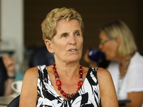 Ontario Premier Kathleen Wynne talks to Barrie Examiner reporter Joelle Kovach on Wednesday, Aug. 2, 2017 at the Silver Bean Cafe in Peterborough, Ont. (Clifford Skarstedt/Peterborough Examiner/Postmedia Network)