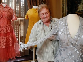 Luke Hendry/The Intelligencer
Glanmore National Historic Site curator Rona Rustige displays a 1970s gown donated by Evelyn Bleecker Murphy Tuesday at the museum in Belleville. Murphy had the dress made to attend a governor-general's ball.