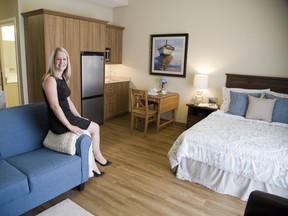 Oakcrossing Retirement Living?s Holly Jordan shows off one of the rooms being offered rent-free to Western University music students in exchange for providing musical entertainment to residents. (Derek Ruttan/The London Free Press)